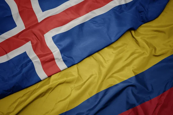 Waving colorful flag of colombia and national flag of iceland. — Stock Photo, Image