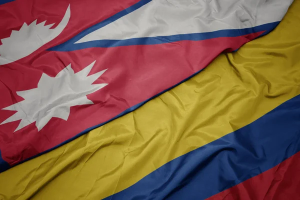 Acenando bandeira colorida da colômbia e bandeira nacional do nepal . — Fotografia de Stock