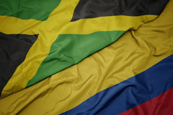 Ondeando colorida bandera de colombia y bandera nacional de jamaica . —  Fotos de Stock