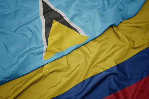 Acenando bandeira colorida da colômbia e bandeira nacional de santa Lúcia — Fotografia de Stock