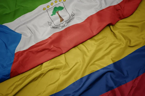 Ondeando colorida bandera de Colombia y bandera nacional de Guinea Ecuatorial . —  Fotos de Stock