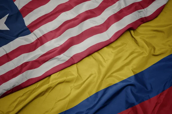 Waving colorful flag of colombia and national flag of liberia. — Stock Photo, Image