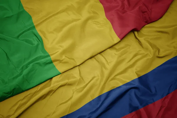 Waving colorful flag of colombia and national flag of mali. — Stock Photo, Image