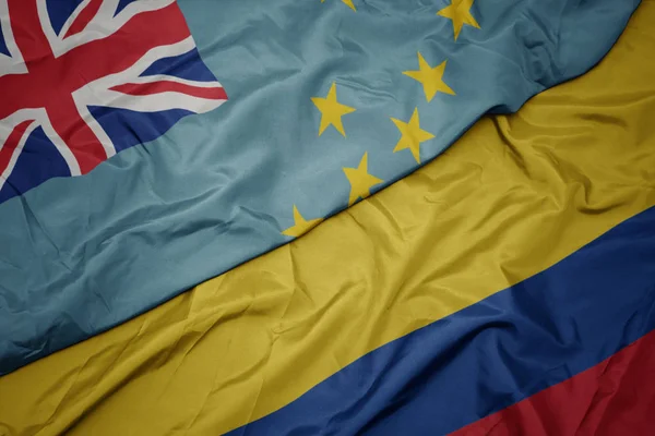 Schwenken bunte Fahne von Kolumbien und Nationalflagge von Tuvalu . — Stockfoto