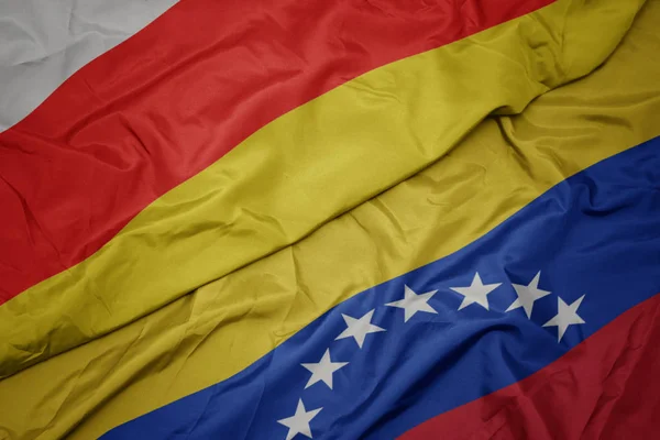 Vifta färgglada flagga Venezuela och nationella flaggan i Sydossetien. — Stockfoto