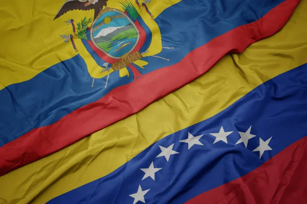 ベネズエラのカラフルな旗とエクアドルの国旗を振る. — ストック写真