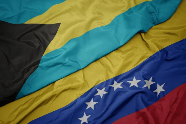 Waving colorful flag of venezuela and national flag of bahamas. — Stock Photo, Image