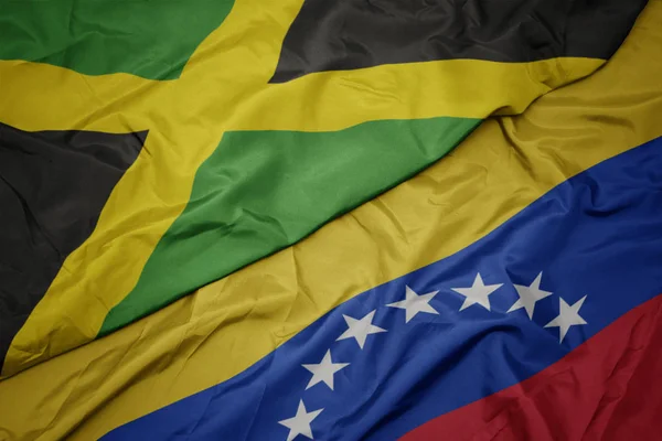 A venezuelai színpompás zászló és Jamaica nemzeti zászlaja. — Stock Fotó