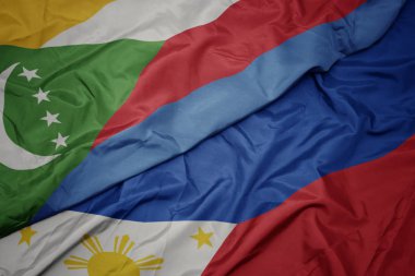 Filipinler ve komor ulusal bayrağı renkli bayrak sallayarak.