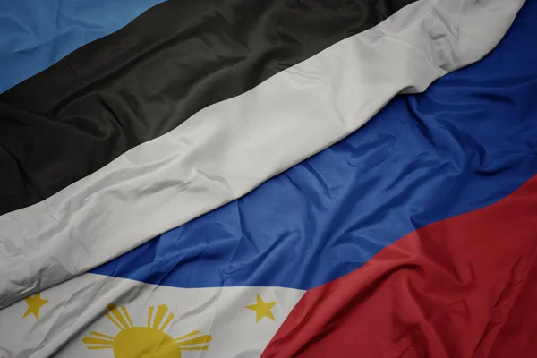 Waving colorful flag of philippines and national flag of estonia. — Stock Photo, Image
