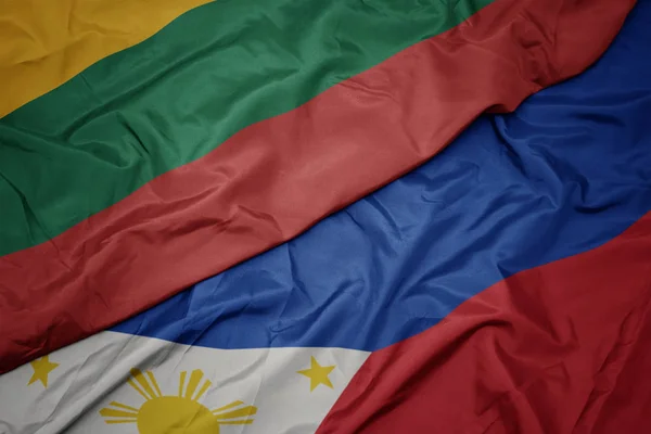 Waving colorful flag of philippines and national flag of lithuania. — Stock Photo, Image