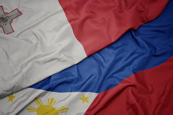 Filipinler ve malta ulusal bayrağı renkli bayrak sallayarak. — Stok fotoğraf