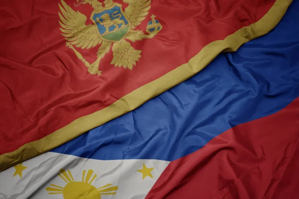 Ondeando colorida bandera de Filipinas y bandera nacional de montenegro . — Foto de Stock