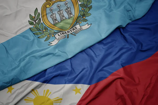 Waving colorful flag of philippines and national flag of san marino. — Stock Photo, Image