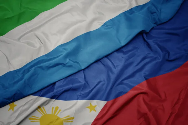 Waving colorful flag of philippines and national flag of sierra leone. — Stock Photo, Image