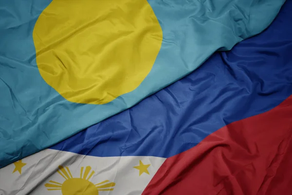 Waving colorful flag of philippines and national flag of Palau . — Stock Photo, Image