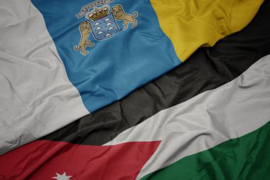 ürdün renkli bayrak ve kanarya adaları ulusal bayrak sallayarak.