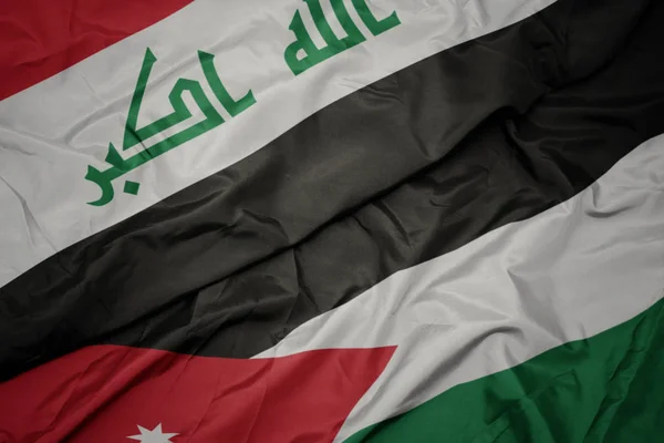 Ürdün ve Irak ulusal bayrağı renkli bayrak sallayarak. — Stok fotoğraf