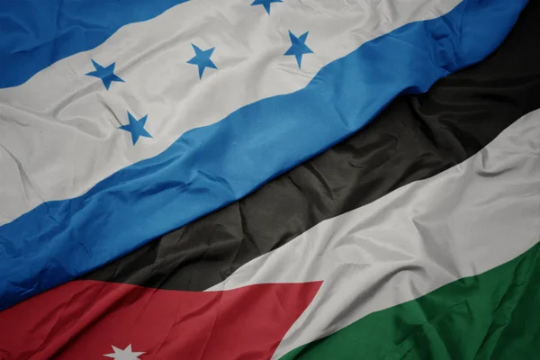 A Jordán zászló színpompás zászlója és Honduras nemzeti zászlaja. — Stock Fotó
