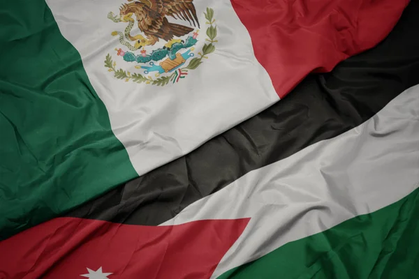 Acenando bandeira colorida da Jordânia e bandeira nacional do México . — Fotografia de Stock