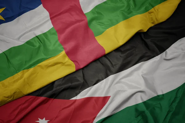 Acenando bandeira colorida da Jordânia e bandeira nacional da república centro-africana . — Fotografia de Stock