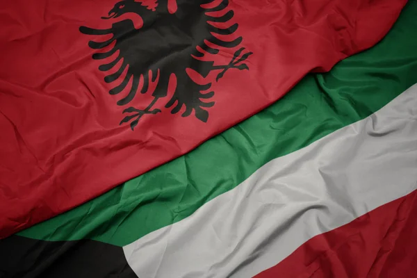 Kuveyt ve arnavutluk ulusal bayrağı renkli bayrak sallayarak. — Stok fotoğraf