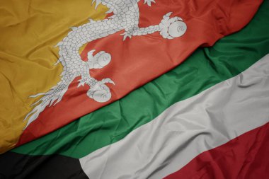 kuveyt ve bhutan ulusal bayrağı renkli bayrak sallayarak.