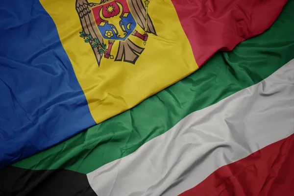 Ondeando colorida bandera de kuwait y bandera nacional de moldova . —  Fotos de Stock