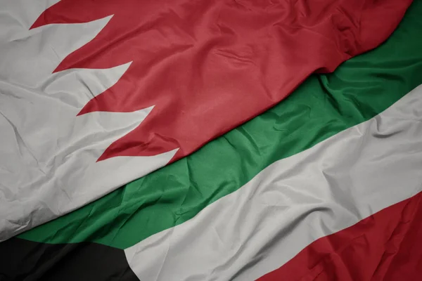 Waving colorful flag of kuwait and national flag of bahrain. — Stock Photo, Image
