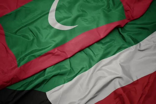 Waving colorful flag of kuwait and national flag of maldives. — Stock Photo, Image