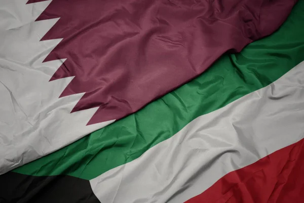 Waving colorful flag of kuwait and national flag of qatar. — Stock Photo, Image