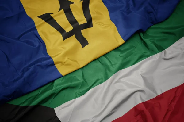 Waving colorful flag of kuwait and national flag of barbados. — Stock Photo, Image