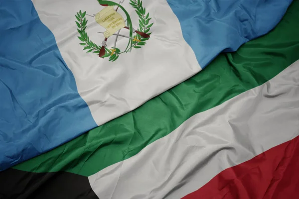 waving colorful flag of kuwait and national flag of guatemala.