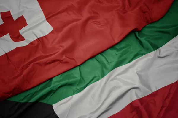 Waving colorful flag of kuwait and national flag of Tonga . — Stock Photo, Image