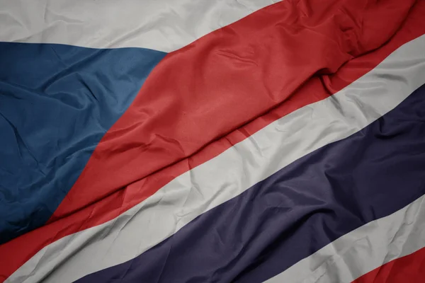 Zwaaiende kleurrijke vlag van Thailand en de nationale vlag van Tsjechië. — Stockfoto