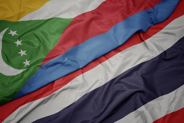 Waving colorful flag of thailand and national flag of comoros. — Stock Photo, Image