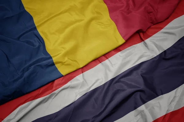 Mávající barevná vlajka Thajska a národní vlajka Čadu. — Stock fotografie