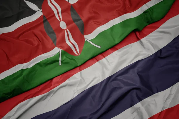 Sventolando bandiera colorata della Thailandia e bandiera nazionale del Kenya . — Foto Stock