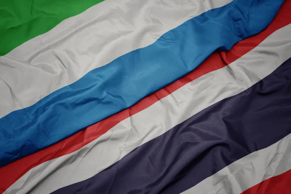 Schwenken bunte Flagge von Thailand und Nationalflagge von Sierra Leone — Stockfoto