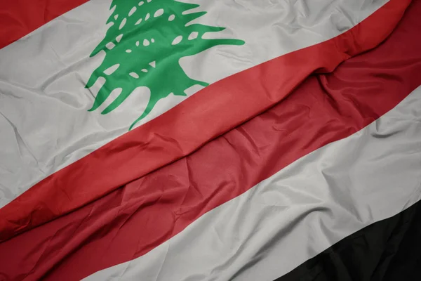 Waving colorful flag of yemen and national flag of lebanon. — Stock Photo, Image