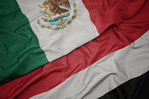 Ondeando colorida bandera de yemen y bandera nacional de mexico . —  Fotos de Stock