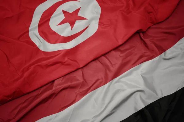 Waving colorful flag of yemen and national flag of tunisia. — Stock Photo, Image