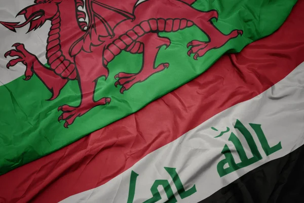 Waving colorful flag of iraq and national flag of wales. — Stock Photo, Image