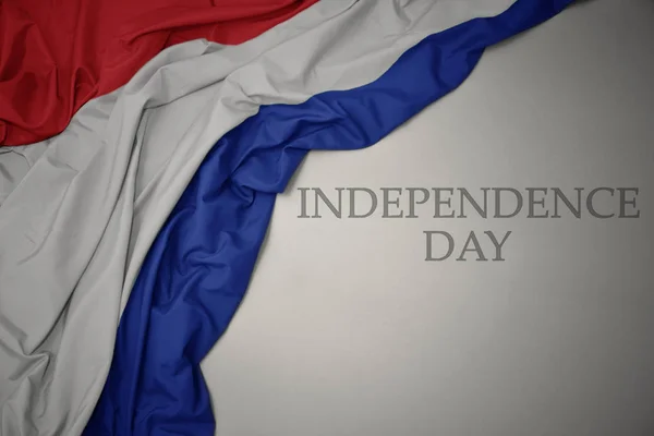 Acenando bandeira nacional colorida de terras baixas em um fundo cinza com dia de independência de texto . — Fotografia de Stock