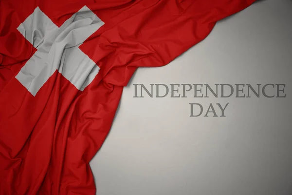 Waving colorful national flag of switzerland on a gray background with text independence day. — Stock Photo, Image