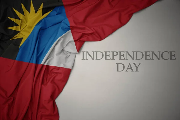 A színes nemzeti zászló Antigua és Barbuda, szürke háttér, szöveg függetlenség napja. — Stock Fotó