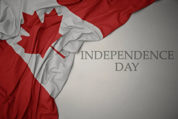 Waving colorful national flag of canada on a gray background with text independence day. — 스톡 사진