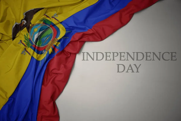 Waving colorful national flag of ecuador on a gray background with text independence day. — Stockfoto