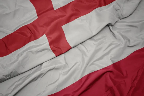 Waving colorful flag of poland and national flag of england. — Stock Photo, Image