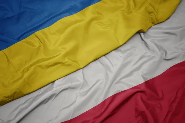 Waving colorful flag of poland and national flag of ukraine. — Stock Photo, Image